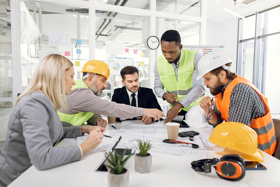 Multiracial Team Of Businesspeople And Architects Working With D